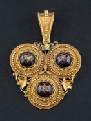 A gold, Victorian, cannetaille, trefoil pendant,: set with cabochon-cut garnets,