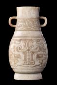 A Chinese pale celadon and grey jade archaistic vase: of flattened baluster form with simple loop