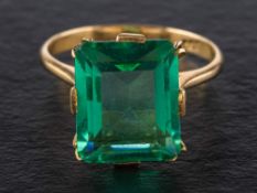 A step-cut green paste ring,: stamped '18C', length of ring head ca. 1.