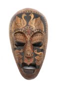 An African painted tribal mask: decorated with exotic birds and geometric designs, 33cm high.