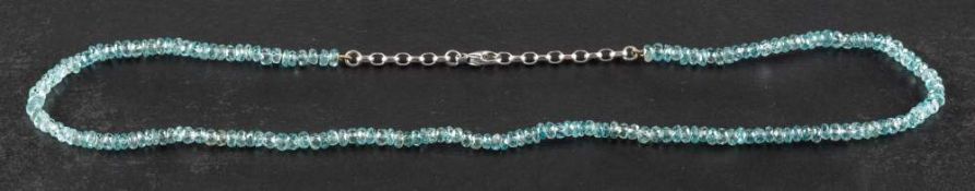 A faceted aquamarine bead necklace,: diameter of beads ca. 4mm, the clasp stamped '750', length ca.