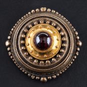A 15ct gold, late Victorian, Etruscan Revival style, cabochon-cut garnet brooch,: diameter ca. 3.