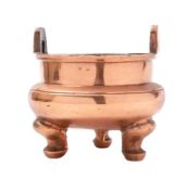 A Chinese copper censer: of circular form, with pierced lug handles to the rim,