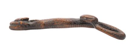A Japanese carved boxwood okimono of a snake and toad: with hardstone eyes,