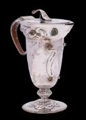 Archibald Knox for Liberty & Co, a silver 'Cymric' pedestal jug, maker Liberty & Co, Birmingham,