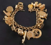 A double-link chain charm bracelet,: stamped '14K', with various charms including a tram,