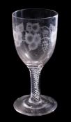 A large wine glass and an oil and vinegar bottle: the bowl engraved with fruiting vine and set on