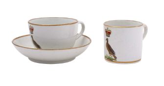 An early 19th century English porcelain armorial trio: the tea cup of Bute shape,