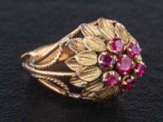 A mid-20th century, ruby dress ring of stylised flowerhead design,: length of ring head 2.