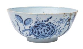 An English delftware bowl: the exterior painted in blue with large rose sprays,