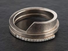 An 18ct gold, round, brilliant-cut, half-eternity ring,: estimated total diamond weight ca. 0.
