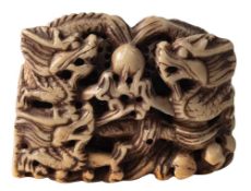 A Chinese carved soapstone seal: of rectangular outline decorated with dragons chasing pearls of