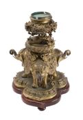 A Chinese bronze stand: with pierced circular bowl supported by a dragon standing on a lotus flower,