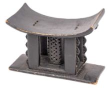 An ebonised wood Asante (or Ashanti) stool, early 20th century,: with dished rectangular seat,
