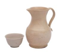 A Staffordshire white saltglaze baluster jug and a similar teabowl: the jug with reeded loop handle,