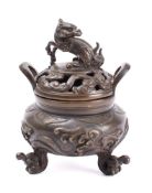 A Japanese bronze koro and cover: the pierced shallow domed cover surmounted with a dragon,
