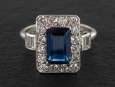 A rectangular step-cut sapphire, baguette and round-brilliant cut diamond cluster ring,