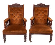 A pair of Victorian mahogany, upholstered and studded library armchairs in Aesthetic Movement taste,