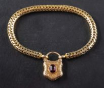 A snake-link bracelet with an engraved cartouche locket clasp,