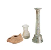 A Roman glass bottle: of slender bell-shaped form,
