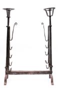 A 17th Century Continental wrought iron porte de cheminée: with twin circular cresset baskets on
