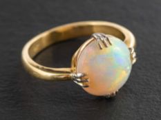 A circular, cabochon-cut, opal ring,: estimated opal weight ca. 2.