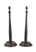 A pair of 19th century mahogany candlesticks: of slender tapering form,
