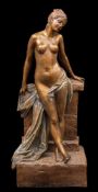 A large Goldscheider Art Nouveau bronzed earthenware figural lamp base: in the form of a semi-naked
