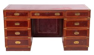 A mahogany veneered and crossbanded pedestal desk, in the style of 19th century campaign furniture,