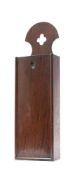 A George III oak candle box: of rectangular outline with pierced cresting and sliding cover,