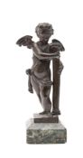An 18th century bronze model of Cupid: leaning against a slender pillar,