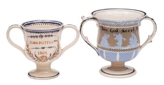 A mid 19th century creamware frog loving-cup and one other in early 19th century style: the first