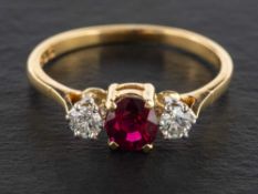 An 18ct gold, ruby and round, brilliant-cut diamond three stone ring,