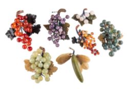 A collection of late 19th century polished hardstone fruits: including bunches of grapes, banana,