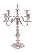 A 19th Century silver plated four-branch candelabrum: with reeded scrolling arms terminating in