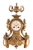 A gilt-metal and porcelain French mantel clock: the eight-day duration movement striking the hours