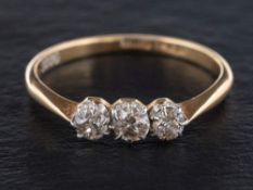 A round, brilliant-cut, three-stone diamond ring,: estimated total diamond weight ca. 0.
