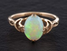 A cabochon-cut opal ring,: length of ring head ca. 2cm, ring size O, total weight ca. 2.1gms.