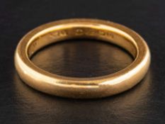 A 22ct gold band ring,: with hallmarks for Birmingham, 1928, ring size N, total weight ca. 6.7gms.