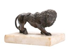 A Regency period bronze model of a lion: saddled, mounted on a marble base, 10cm long.