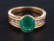 An oval, mixed-cut emerald and baguette-cut diamond ring,: calculated weight of emerald ca.