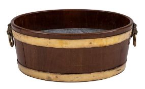 A George III mahogany and brass banded cellaret, late 18th century,: of oval section,