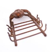 A novelty bronze desk top thermometer: modelled as a toad holding a ladder,