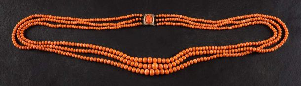 A three-strand graduated coral necklace,