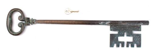 A large 19th century brass key with pivoted bow: possibly a locksmiths advertising key,