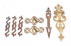 A pair of late 19th/early 20th century brass escutcheons: together with a set of three steel