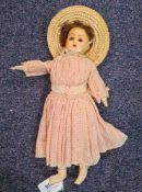 A late 19th /early 20th century wax head doll with brown wig,