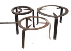 Three circular iron brandreths:, one with a handle, each on tripod feet, 42cm,