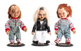 Two unboxed Chucky dolls and a Tiffany doll on stands: (3)