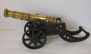 A brass and cast iron model of a cannon: with five stage brass barrel,